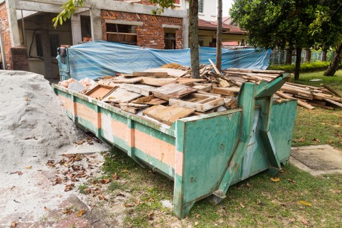 Front view of a commercial waste collection vehicle in an urban Norwood street